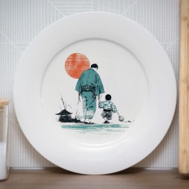 White plate with a Japanese-style illustration of an adult and child walking under a red sun