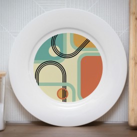 White plate with a retro geometric pattern in green, beige, black, and orange