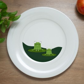White plate with an illustration of two frogs on lily pads